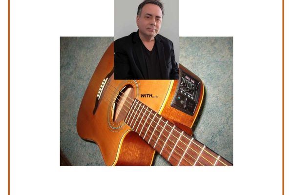 A man in a black jacket and shirt; an electric acoustic guitar